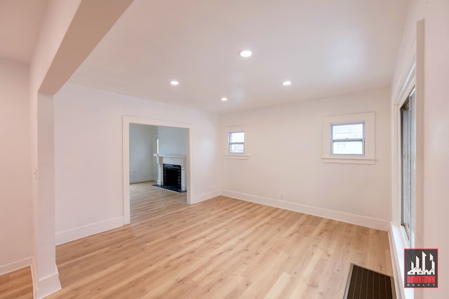 unfurnished room featuring a healthy amount of sunlight and light hardwood / wood-style floors