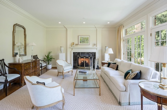 living room with crown molding, a fireplace, and light hardwood / wood-style floors