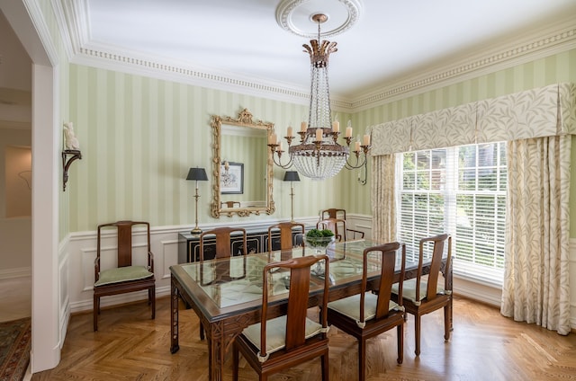 dining room featuring parquet flooring, ornamental molding, and a chandelier