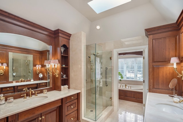 bathroom featuring shower with separate bathtub, lofted ceiling with skylight, and vanity