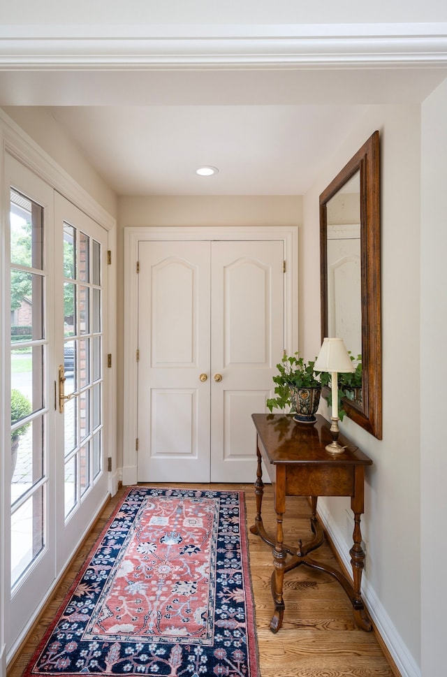 entryway featuring hardwood / wood-style floors and french doors