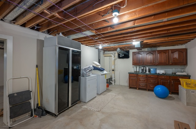 basement featuring black refrigerator and washer and dryer