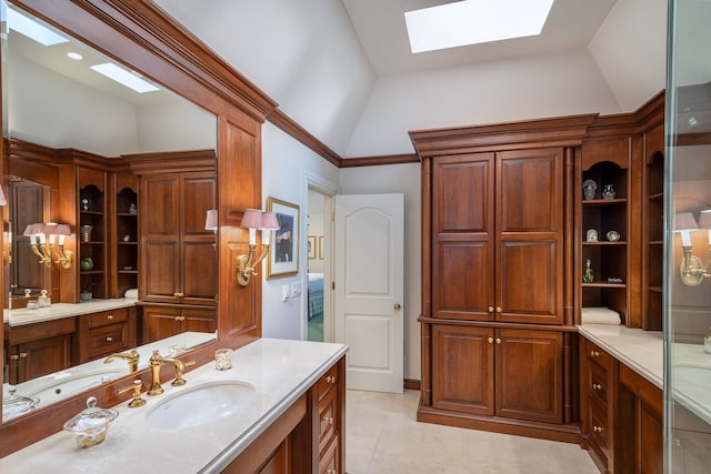 bathroom featuring tile patterned floors, vanity, and lofted ceiling with skylight