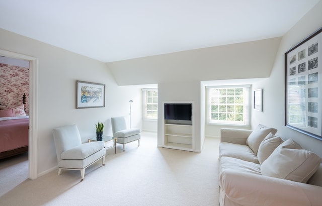 carpeted living room with vaulted ceiling