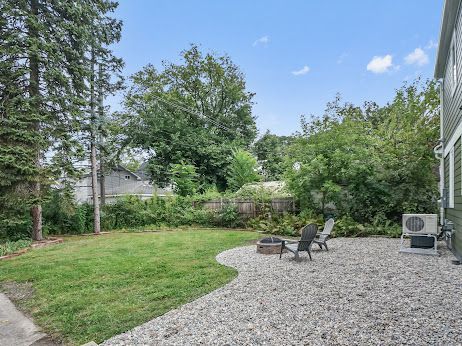 view of yard with ac unit, a patio, and an outdoor fire pit