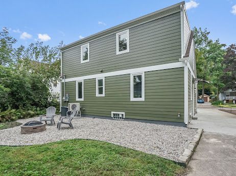 rear view of house with a fire pit and a patio area