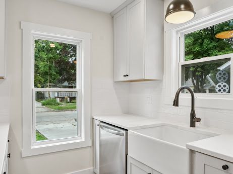 kitchen featuring sink, stainless steel dishwasher, and white cabinets