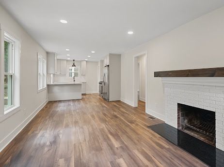 unfurnished living room with a fireplace and wood-type flooring