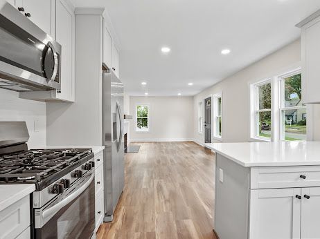 kitchen with white cabinetry, appliances with stainless steel finishes, and light wood-type flooring