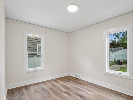 spare room with wood-type flooring