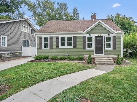 bungalow-style house featuring a front yard