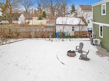 snowy yard featuring a fire pit