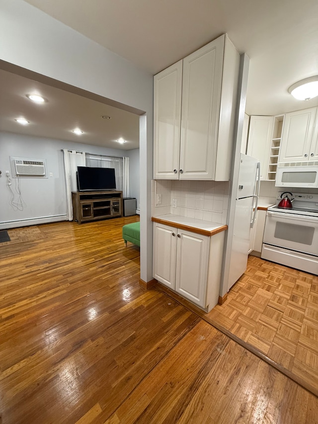 kitchen with white cabinetry, backsplash, white appliances, and a wall unit AC