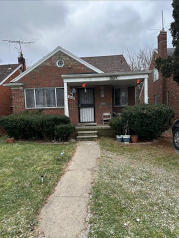 bungalow-style house with a front lawn and a porch