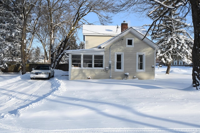 view of snow covered rear of property