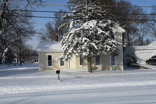 view of front of home featuring a garage and an outdoor structure