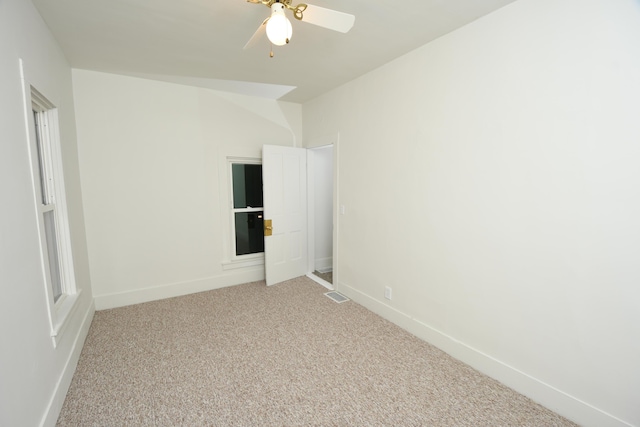 spare room featuring ceiling fan and carpet flooring