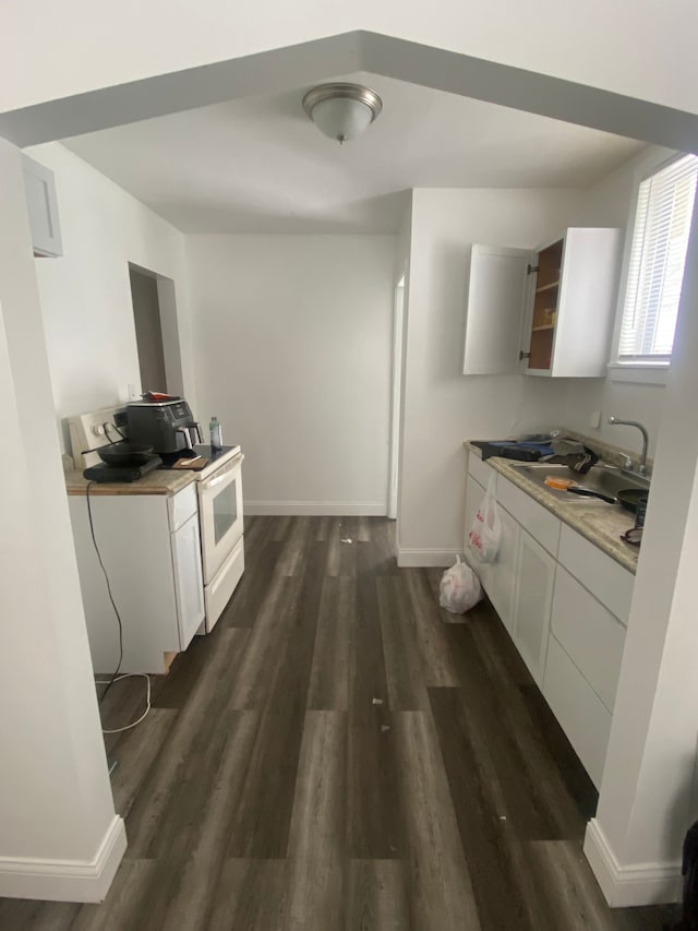 kitchen with white cabinetry, dark wood-type flooring, sink, and electric stove