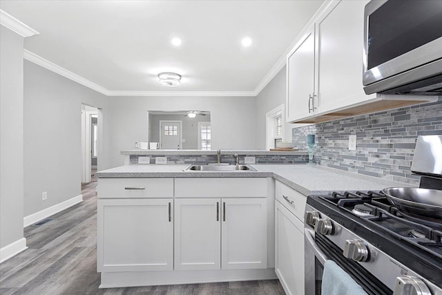 kitchen with sink, white cabinets, and stainless steel appliances