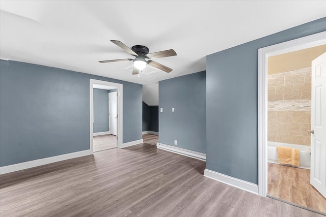 spare room with ceiling fan and wood-type flooring