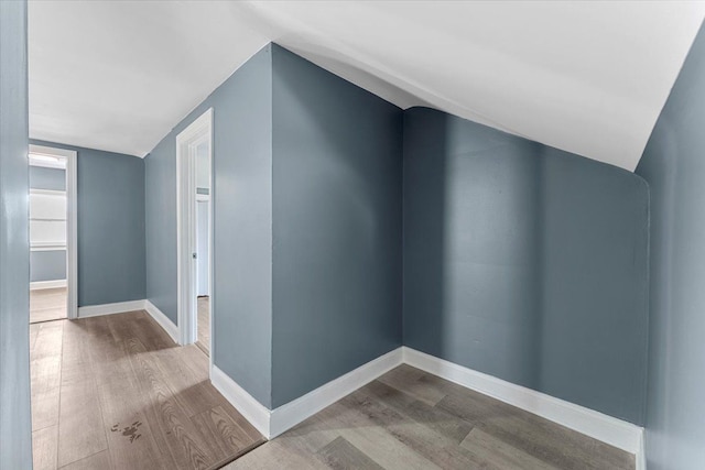 interior space with light hardwood / wood-style floors and lofted ceiling