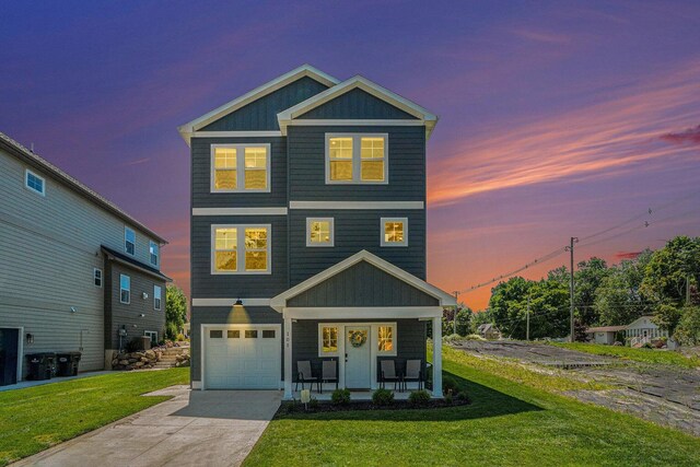 108 Elkenburg St Unit 18, South Haven, MI 49090 - view of front of house with a garage, a lawn, and covered porch