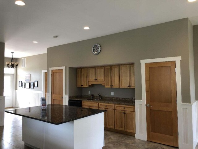108 Elkenburg St Unit 18, South Haven, MI 49090 - kitchen featuring dishwasher, a kitchen island, decorative light fixtures, an inviting chandelier, and sink