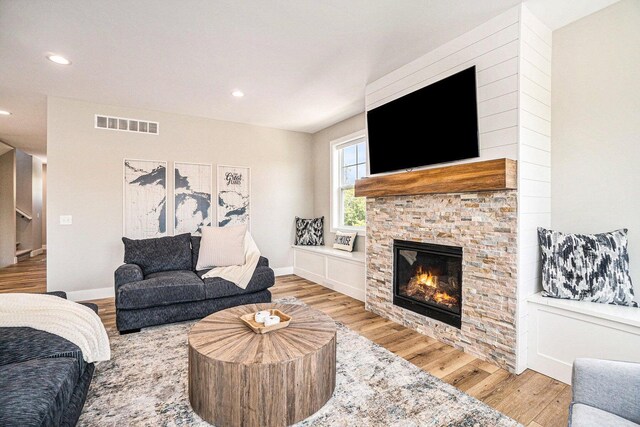 108 Elkenburg St Unit 18, South Haven, MI 49090 - living room with a stone fireplace and light wood-type flooring