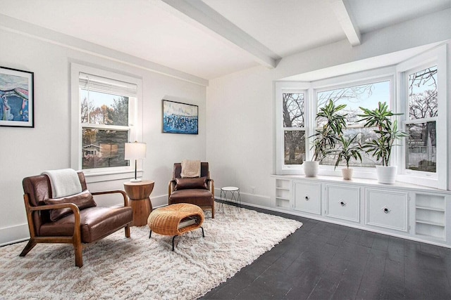 living area with beamed ceiling and dark hardwood / wood-style flooring