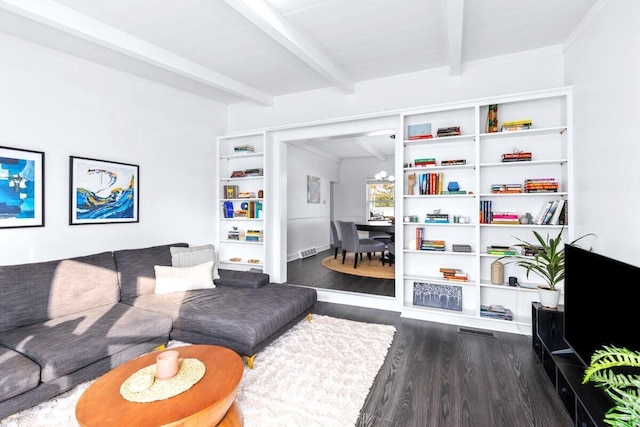 living room with beamed ceiling and dark hardwood / wood-style floors