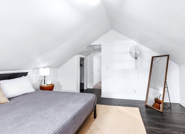 bedroom featuring dark hardwood / wood-style flooring and lofted ceiling