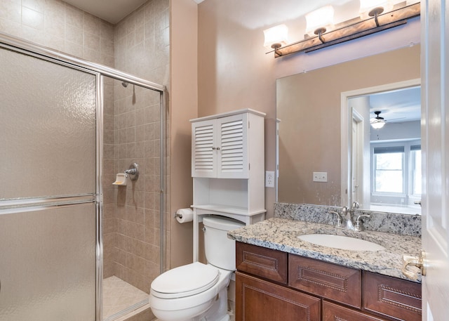 bathroom with toilet, a shower with shower door, and vanity