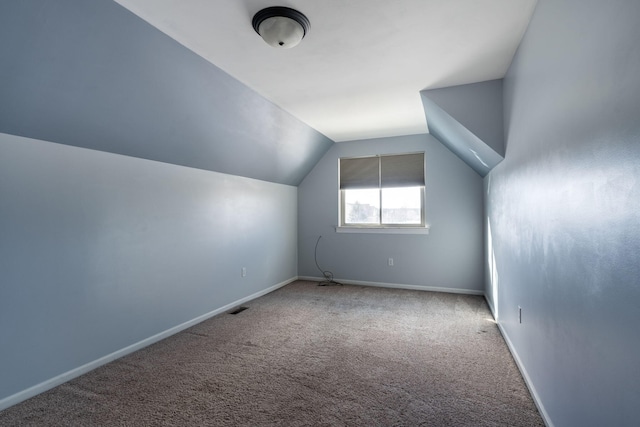 additional living space with carpet floors and lofted ceiling