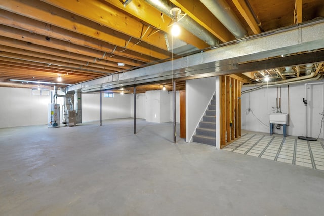 basement with gas water heater, sink, and heating unit