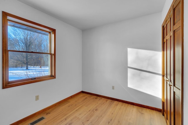 spare room featuring light wood-type flooring