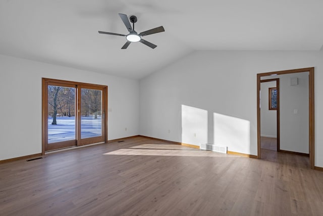 spare room with ceiling fan, lofted ceiling, and light wood-type flooring