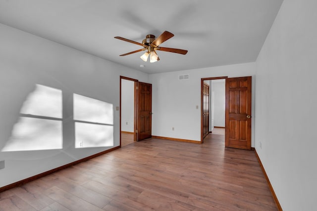 unfurnished room with hardwood / wood-style floors and ceiling fan