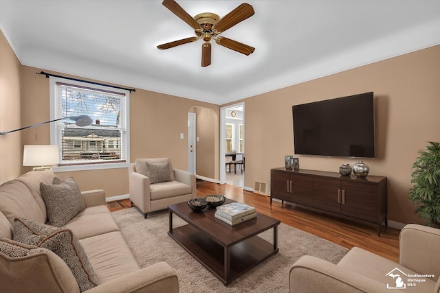 living room featuring ceiling fan and light hardwood / wood-style flooring