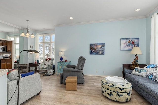 living room with light hardwood / wood-style flooring and ornamental molding