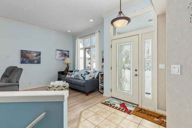 foyer entrance featuring crown molding and light hardwood / wood-style floors