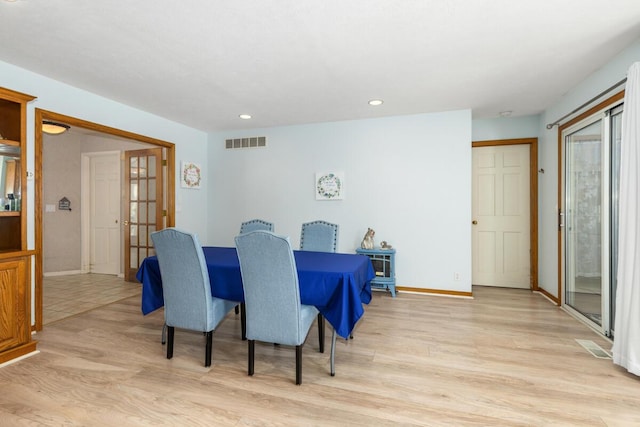 dining space with light hardwood / wood-style flooring