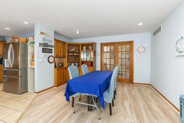 dining space featuring light hardwood / wood-style floors and french doors