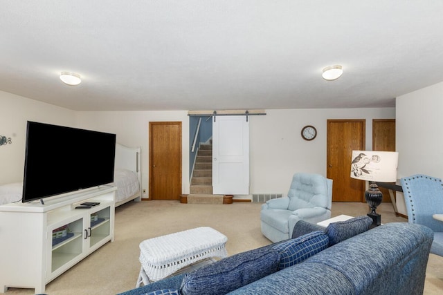 carpeted living room with a barn door