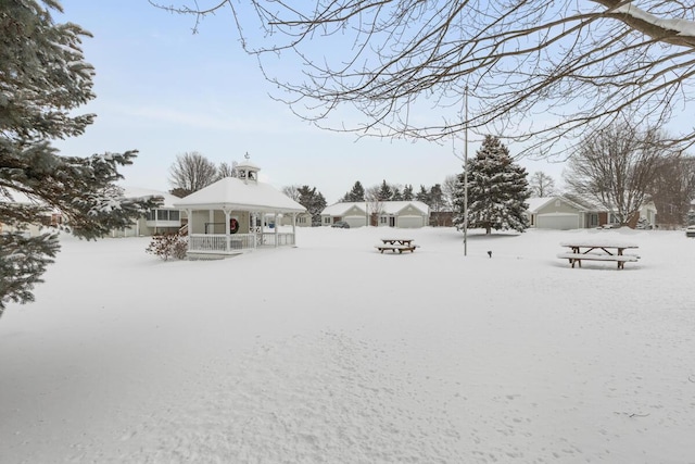 yard layered in snow featuring a gazebo