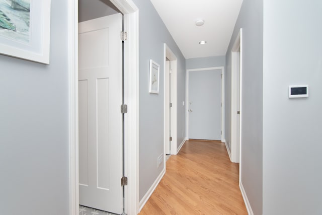 hallway with light hardwood / wood-style flooring