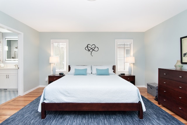 bedroom featuring wood-type flooring and ensuite bathroom