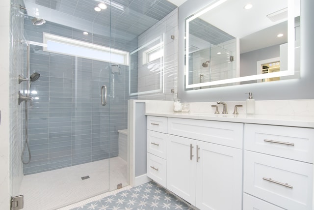 bathroom with vanity and a shower with shower door