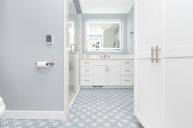 bathroom featuring vanity and a shower with shower door