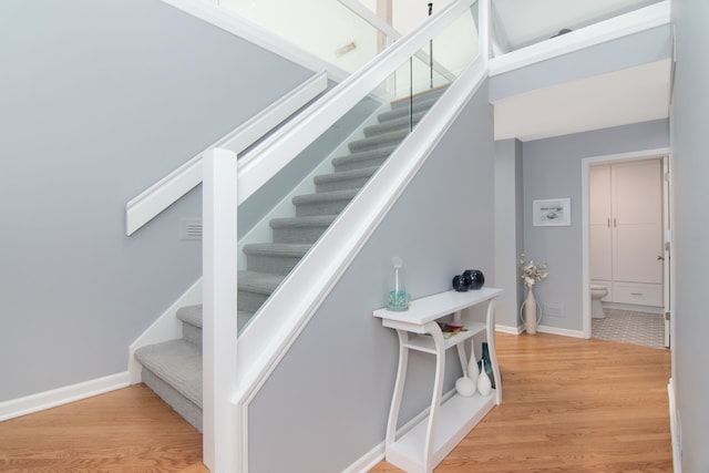 staircase featuring wood-type flooring