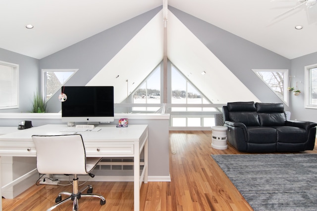 office area featuring vaulted ceiling, ceiling fan, and light wood-type flooring